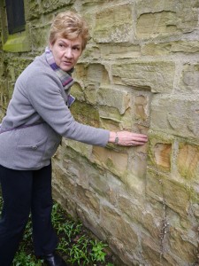 Penny shows us the location of the "leper slip" in the north side of St. Lawrence Church, where in olden times, those with disease could come and be handed the body of Christ through a slit between stones in the wall.